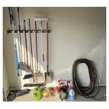 Contents of garage wall, yard tools, hose,