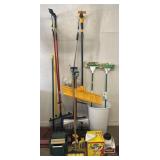 Group of cleaning supplies, brooms, shovels, mops