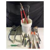 Group of yard tools, loppers, trimmers, saws,