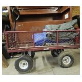 Red, metal rolling garden cart w/ tarps. Tires