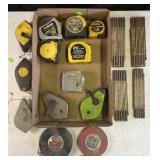 Group of tape measurers and chalk line reels