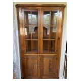 Pine corner cabinet with upper glass doors and
