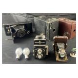 3 antique cameras and decorative accessories