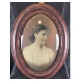 Framed portrait of woman in period attire, convex