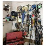Contents of garage wall, oilers, pumps, hand