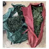2 pre-lit Christmas trees in storage bags,