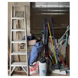 Group of brooms, mops, ladder, sprayer, camp