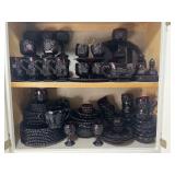 Collection of Ruby glass in kitchen cabinet,