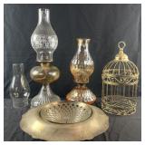 Group of oil lamps, bird cage and silver plate