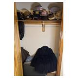 Contents of entry closet, navy peacoat, hats (12