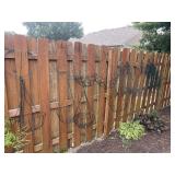 Group of hanging planters, garden fencing and
