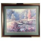 Framed print depicting an old stone bridge,