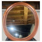 Oval wall mirror with cherry frame, 28' x 33'