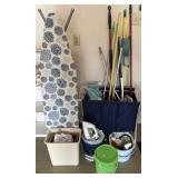 Group of cleaning supplies, brooms, iron and