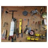 Contents of wall above work bench: hand tools,