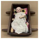 Doll cradle with porcelain doll