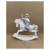girl on rocking horse figure