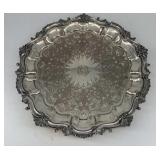 Silver-plated serving tray with an ornate design a