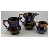 (3) Copper Lusterware creamers, various size, blue