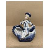 Porcelain figurine of girls sitting on boat