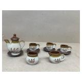 Miniature teacup, saucers, cream, and sugar