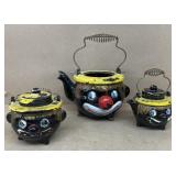 Clown wear tea, pot, cream, and sugar