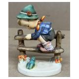 Hummel boy sitting on fence with frog