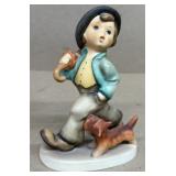 Hummel boy walking with dog