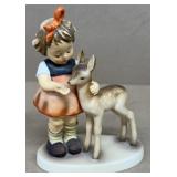 Hummel girl feeding deer