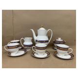 Coffee pot cup saucers, cream, and sugar