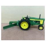 John Deere 720 tractor with grader