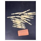 (17) cocktail forks ivory in color