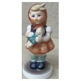 Hummel girl holding baby doll