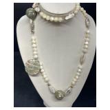 White beaded shell necklace clasp is marked 14 K