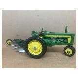 John Deere tractor with four bottom plow