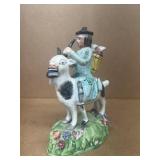 Pottery man riding Billygoat with a basket of pigs