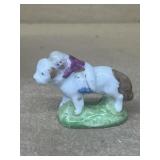 Porcelain girl, riding dog figure