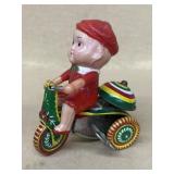 Wind up boy on bicycle