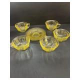 Yellow glass, cups, and saucers