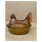 Amber glass hen on a nest does have crack