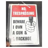 No trespassing beware I own a gun metal sign