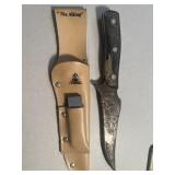 Hunting knife with sharpening stone and sheath