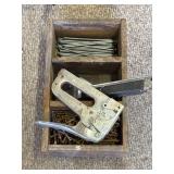 Stapler and nails in the wooden box