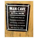 Man, cave rules sign