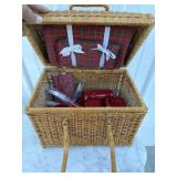 Wicker picnic basket with cups plates, and