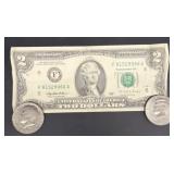 Two dollar bill and two Kennedy half dollars
