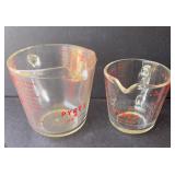 Two Pyrex measuring cups