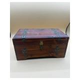 Vintage wooden jewelry box filled with jewelry
