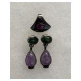 sterling silver dangle earrings feature a green