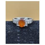 sterling silver ring features a faceted orange